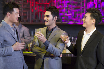 Young friends chatting at bar