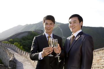 Businessmen having champagne on the Great Wall