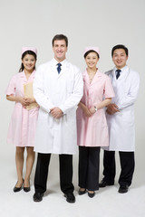 Doctors with nurses in pink uniforms