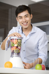 Man making fresh fruit juice