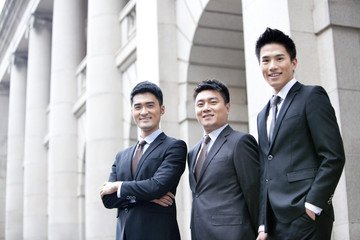 Portrait of confident business team in front of a building, Hong Kong