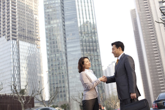 Businesspeople shaking hands in the financial district