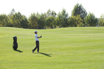 Young Man Taking a Golf Swing