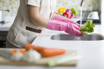 Domestic staff washing vegetables