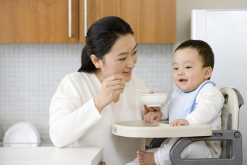 Woman feeding infant