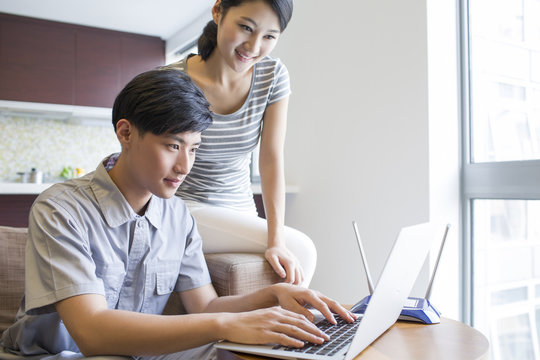 Engineer repairing laptop in customer's home
