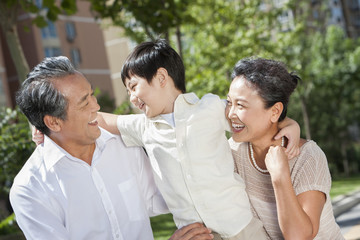 Amused grandparents and grandson