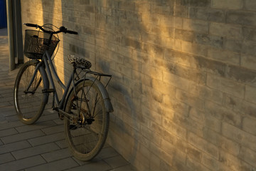 Naklejka na ściany i meble A Vintage Bicycle Leaning Against A Wall