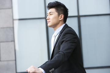 Businessman leaning on a railing deep in thought