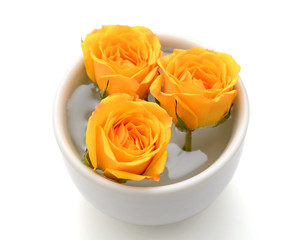beautiful yellow roses inside the cup decorating wedding dinner table