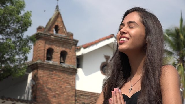 Happy Teen Hispanic Girl Praying at Church