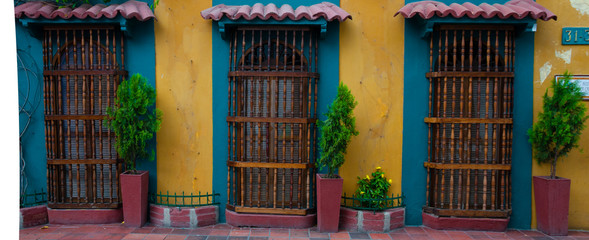 Yellow colonial house front with three doors