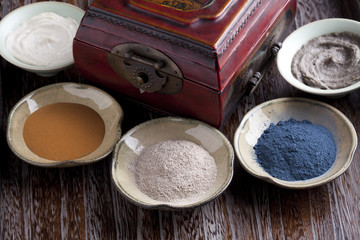 Various facial care products around wood box