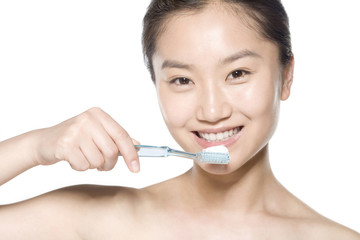 Young woman about to brush her teeth