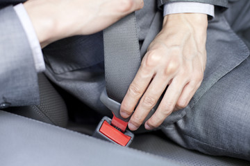 Businessman fastening the seat belt