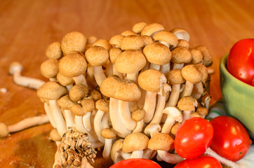 Tomatoes and mushroom , cooked on the old wooden table
