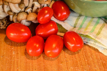 Tomatoes and mushroom , cooked on the old wooden table