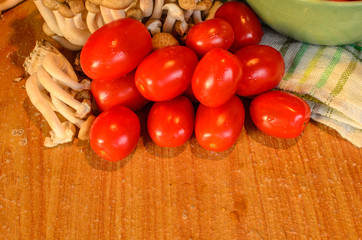 Tomatoes and mushroom , cooked on the old wooden table