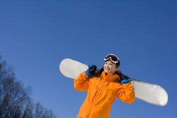 Young woman with her snowboard