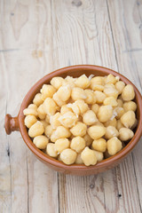 Chickpeas on glass bowl on wooden table