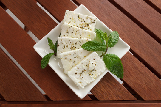Greek feta cheese on wooden table