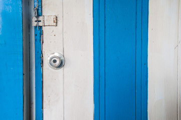 Stainless steel white and blue wood door knob and a key hole
