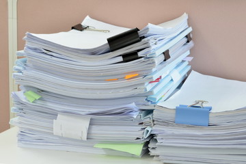 stack of documents on desk at workplace