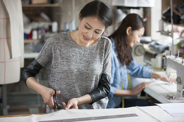 Two fashion designers working in studio