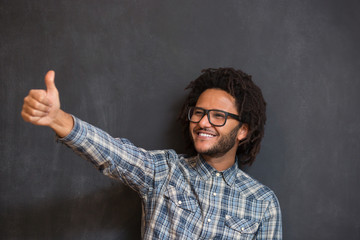 young handsome afro american boy hipster gesturing emotional on