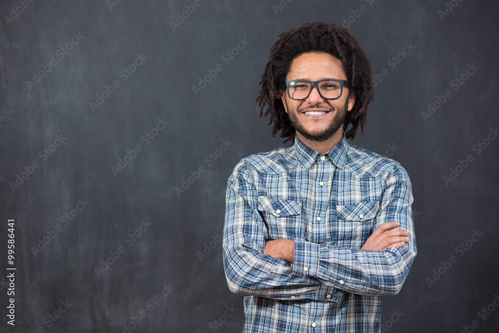 Wall mural young handsome afro american man gesturing emotional posingon ch