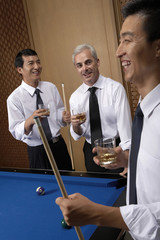 Professionals toast over billiards