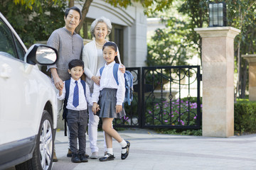 Portrait of senior couple and their grandchildren