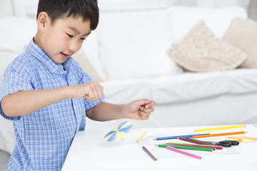 Boy making a paper toy