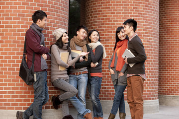 College students chatting in front of a university building