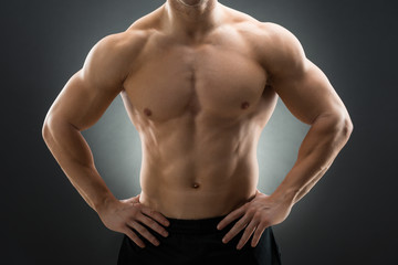 Obraz premium Muscular Man Standing With Hands On Hip