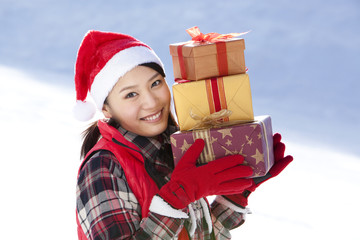 Young woman holding Christmas gift boxes