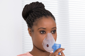 Young Woman Using Oxygen Mask - Powered by Adobe