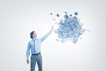 Businessman touching cube 