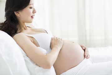 Pregnant woman resting in bed