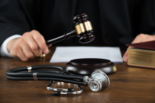 Judge Striking Mallet With Stethoscope At Desk