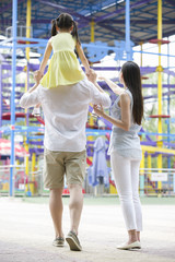 Happy young family playing in amusement park