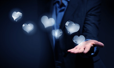 Heart glass icons in palm