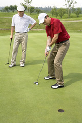 Fototapeta premium Two male Golfers on Green