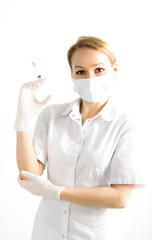 young girl in doctor bathrobe and rubber gloves holding a syringe