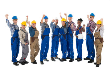 Happy Carpenters Standing With Arms Raised