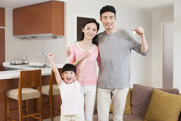 Portrait of happy family cheering with key in hand