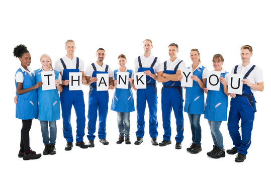Portrait Of Confident Janitors Holding Thank You Sign