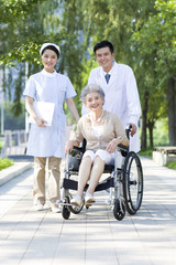 Doctor, nurse and wheelchair bound patient