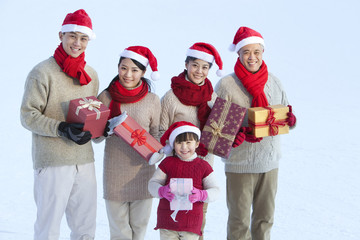 Happy family holding Christmas gifts