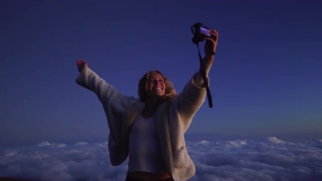 Selfie, Tourist travel photographer photographing selfie sunset view on top of mountain above the clouds.